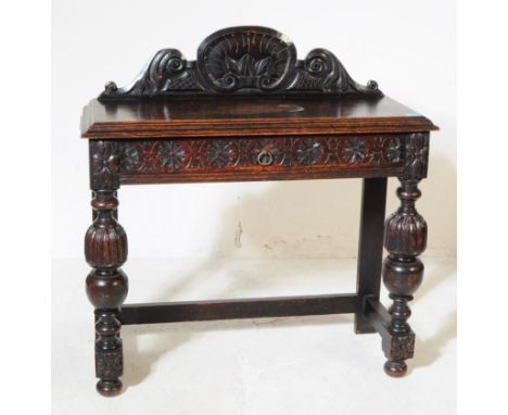 A Victorian 19th century carved oak side / hall / console table. Having a carved shaped gallery back, rectangular chamfered e