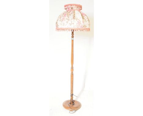 A vintage 20th century floor standing standard lamp. Of mahogany construction with central turned column, light fittings to t