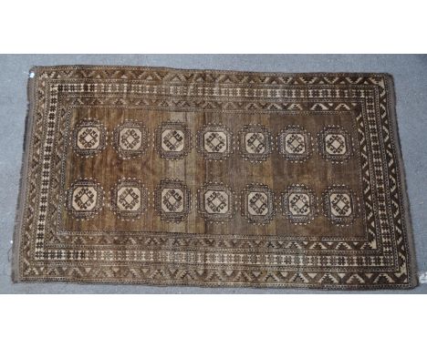 A late 19th century hand knotted Afghan carpet floor rug. The rug having a khaki green ground. With repeating geometric medal
