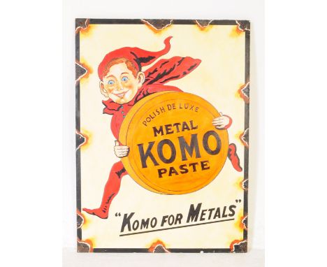 A reproduction faux enamel hand painted Komo metal polish paste advertising board picture. The sign featuring an elf holding 