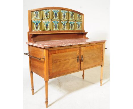 An Edwardian tile back washstand. With a red marble rectangular top and tile splash back with green and blue toned tiles. On 