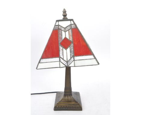A 20th Century art deco Tiffany style table lamp / light having stained glass square shade with repeated geometric pattern in