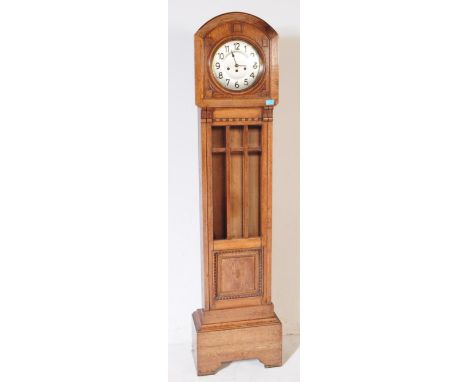 An Art Deco 20th century circa 1930s long case clock. Of oak construction with silver face and ebonised chapter ring. Glazed 