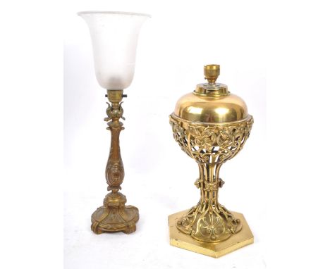 An early 20th century Art Nouveau brass table lamp, alongside another gilt metal example. The Art Nouveau lamp raised on four
