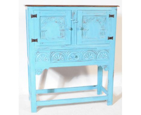 A 20th century Jacobean Revival oak dresser cabinet. The cabinet having twin doors with carved florals, pillars and palmettes