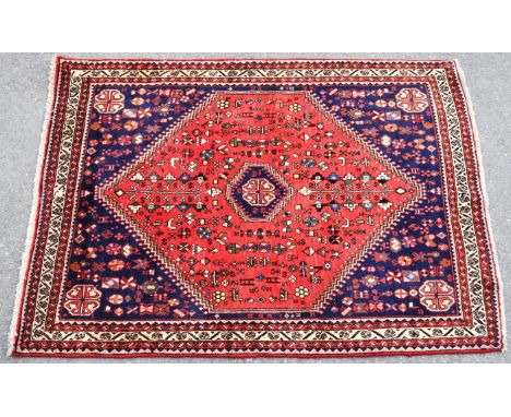 A 20th century South West Persian Abadeh carpet floor rug. The rug having red central field, with small medallion to center, 