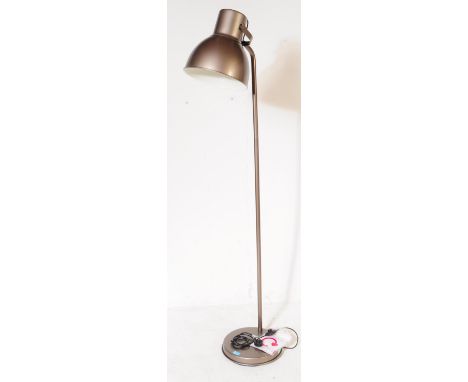 A vintage 20th century oversized industrial floor lamp. The lamp raised on a rounded base, with single bent metal arm and adj