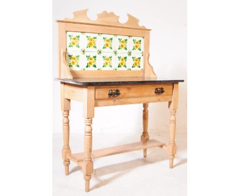 An Edwardian early 20th century pine tile back washstand. With carved top, floral tile back. Rectangular granite top with tur