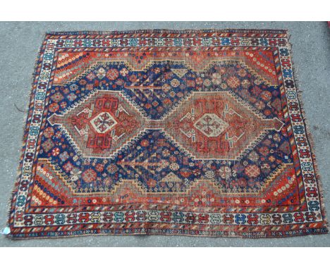 A 19th century hand knotted Persian Iranian Hamadan carpet floor rug. The rug having a red ground, with twin central medallio