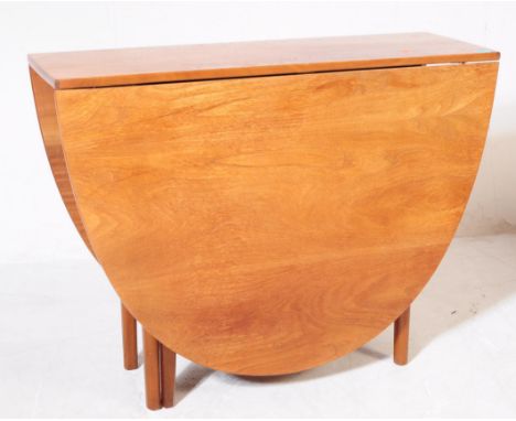 Nathan Furniture - A retro 20th century teak drop leaf space saving dining table. Gate leg support with twin D end drop leaf 