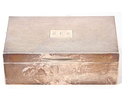 George V table cigarette box of typical form with engine turned decoration to lid, an engraved cartouche, initialled CRC, the