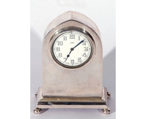 George V silver framed lancet clock of plain polished design, a Swiss made 8-day movement, the enamel dial with Arabic numera