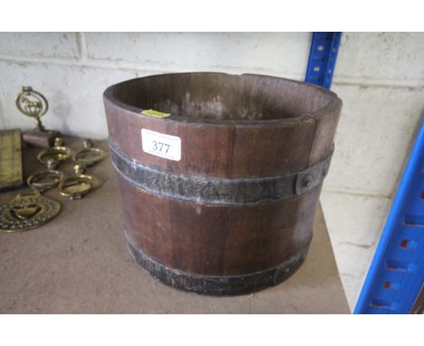 A small coopered barrel drilled out as a planter