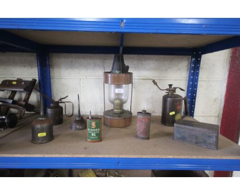 A copper oil lamp, oil cans, a vintage pressure sprayer etc.