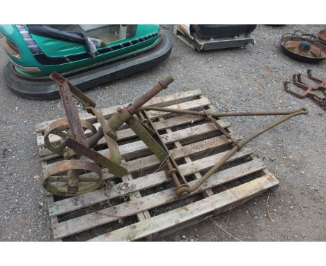 A small vintage dolly wheel with draw bar