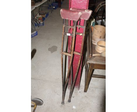 A pair of vintage sprung armed crutches