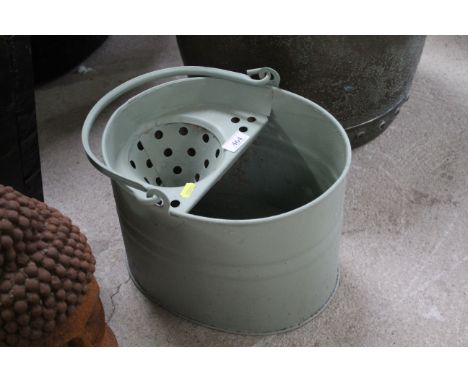 A green painted slop bucket / planter