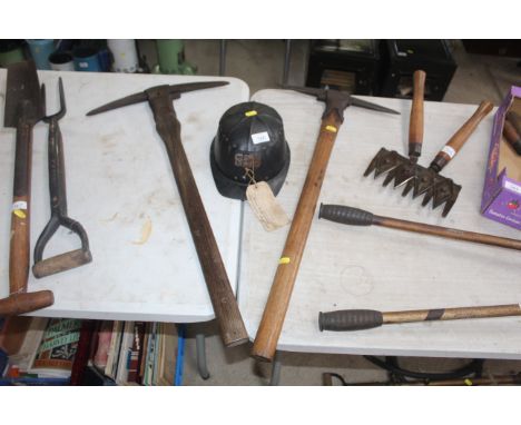 Two very early miners pick axes and a 1946 miners helmet from The Colliery Stores Ryland Works in Chesterfield 