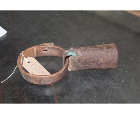 A vintage cow bell with wooden collar and bone knocker