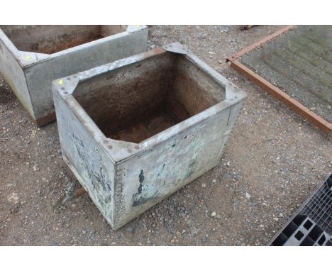 A riveted galvanised water tank drilled out as a planter with brass tap, approx. 27" x 19" x 19"