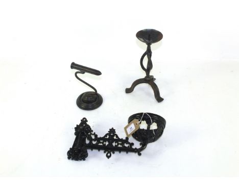 A 19th Century cast iron wall lamp bracket, a wrought iron tripod pricket candlestick and a goffering iron 