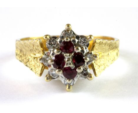 An 18ct yellow and white gold ruby and diamond set cluster ring, (S).