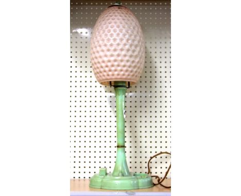 A green Bakelite table lamp with a pink celluloid shade, H. 48cm.