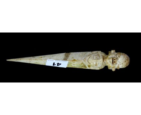 A Tibetan carved white jade/ hardstone purba mounted with the head of a guardian deity, L. 22cm.