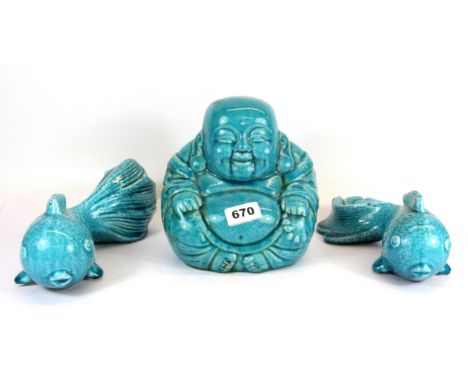 A Chinese blue glazed ceramic figure of the Happy Buddha and two fan tailed fish, Buddha H. 20cm.