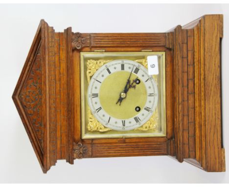 An early 20th century striking oak mantle clock, H. 41cms.