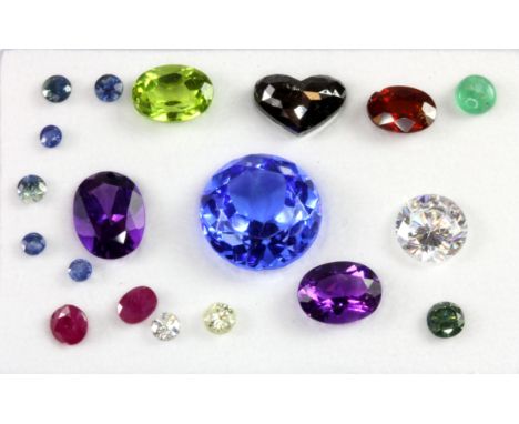 A box of unmounted gemstones, including sapphire, ruby, 1.60ct heart cut diamond and others.