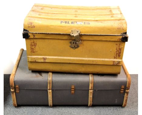 A wood and canvas cabin trunk and a metal cabin trunk.