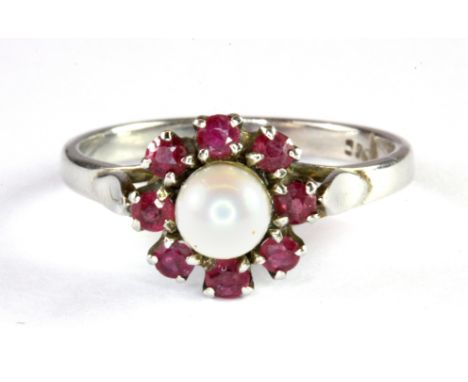 A white metal (tested 9ct gold) ruby and pearl set cluster ring, (N).