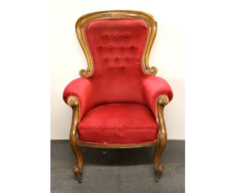 A button backed Victorian walnut armchair.