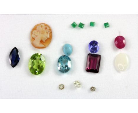 A box of unmounted gemstones, including sapphire, ruby, diamond and opal.