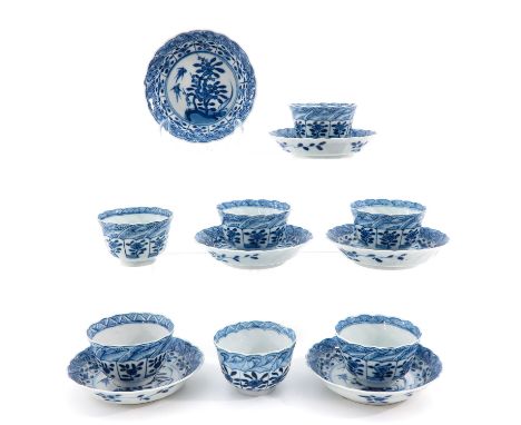 Incluidng 7 cups and 6 saucers, blue and white decor depicting garden scene, marked with double ring and flower, saucers are 