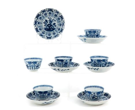 Blue and white decor depicting scene in garden with flowers and butterflies on border, saucers are 13 cm. in diameter.