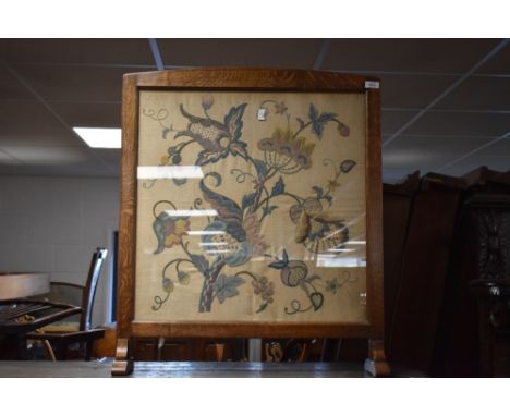 An early 20th Century oak framed tapestry firescreen