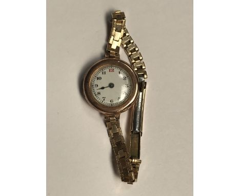 9 carat rose gold ladies watch, white enamel face with arabic markers on a rolled gold strap, 18.3g gross, in working order