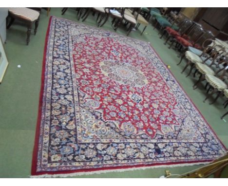 Good large Persian design carpet, dark red ground with stylized floral decoration