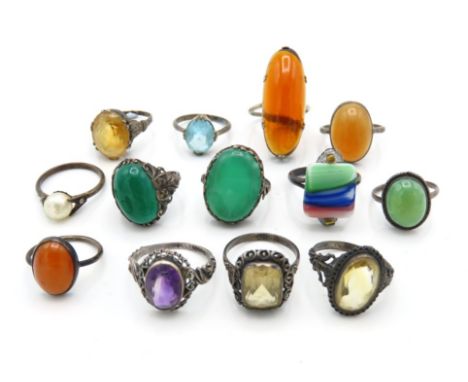 A selection of thirteen vintage & antique silver & white metal rings with stones including jade & amber 