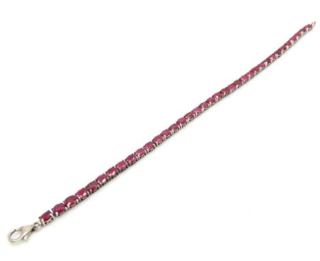 A silver tennis bracelet set with ruby, stones 5.25mm wide, bracelet 195mm long, 8.6g