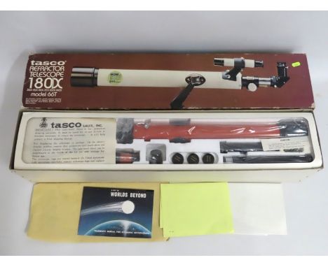 A boxed, sealed & unused Tasco refractor telescope 180x model 66TR with original paperwork & posters 