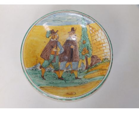 A Montelupo maiolica dish, decorated in a typical palette of ochre, green, blue &amp; brown to depict two male figures visiti