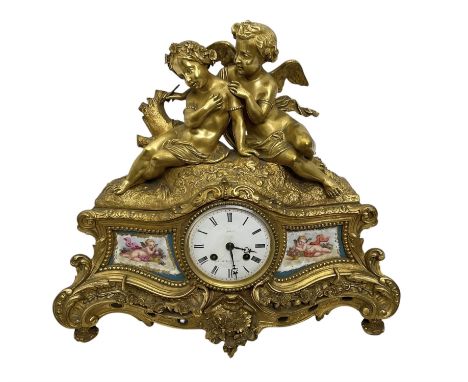 Benoît Félix Richond, Paris - French 8-day gilt mantle clock with surmounted Putti comprising cupid and a lover, with a rococ