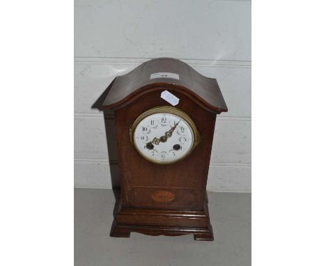 Early 20th Century mantel clock with floral decorated dial set in an arched mahogany case