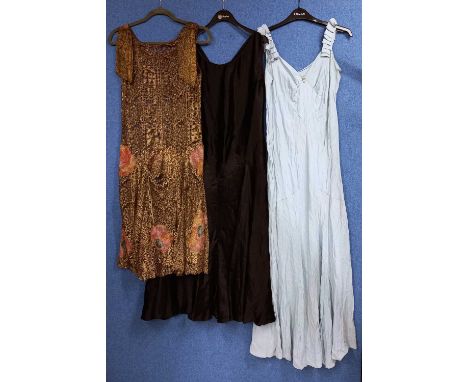 A quantity of c.1920/30's lady's clothing, to include a black velvet cloak by Dickins & Jones, a black satin bias cut sleevel