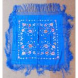 A late 19th/early 20th century blue silk embroidered shawl, covered with embroidered flowers and