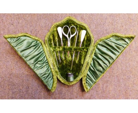 A cased set of matched needlework tools, the green velvet case to include a silver thimble hallmarked Chester 1902, together 