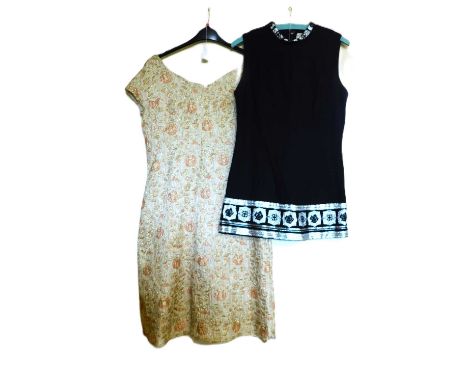 Two c.1960's dresses, to include a black and silver sleeveless shift minidress by Hershelle and a cream and gold floral cappe